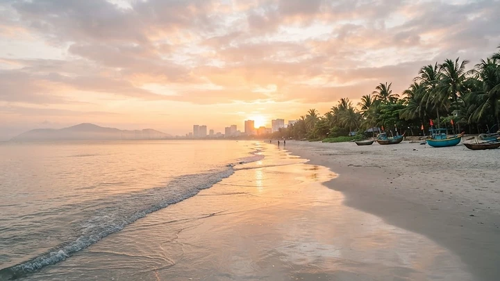 My Khe Beach Da Nang at sunrise with calm waves and golden light on the sand