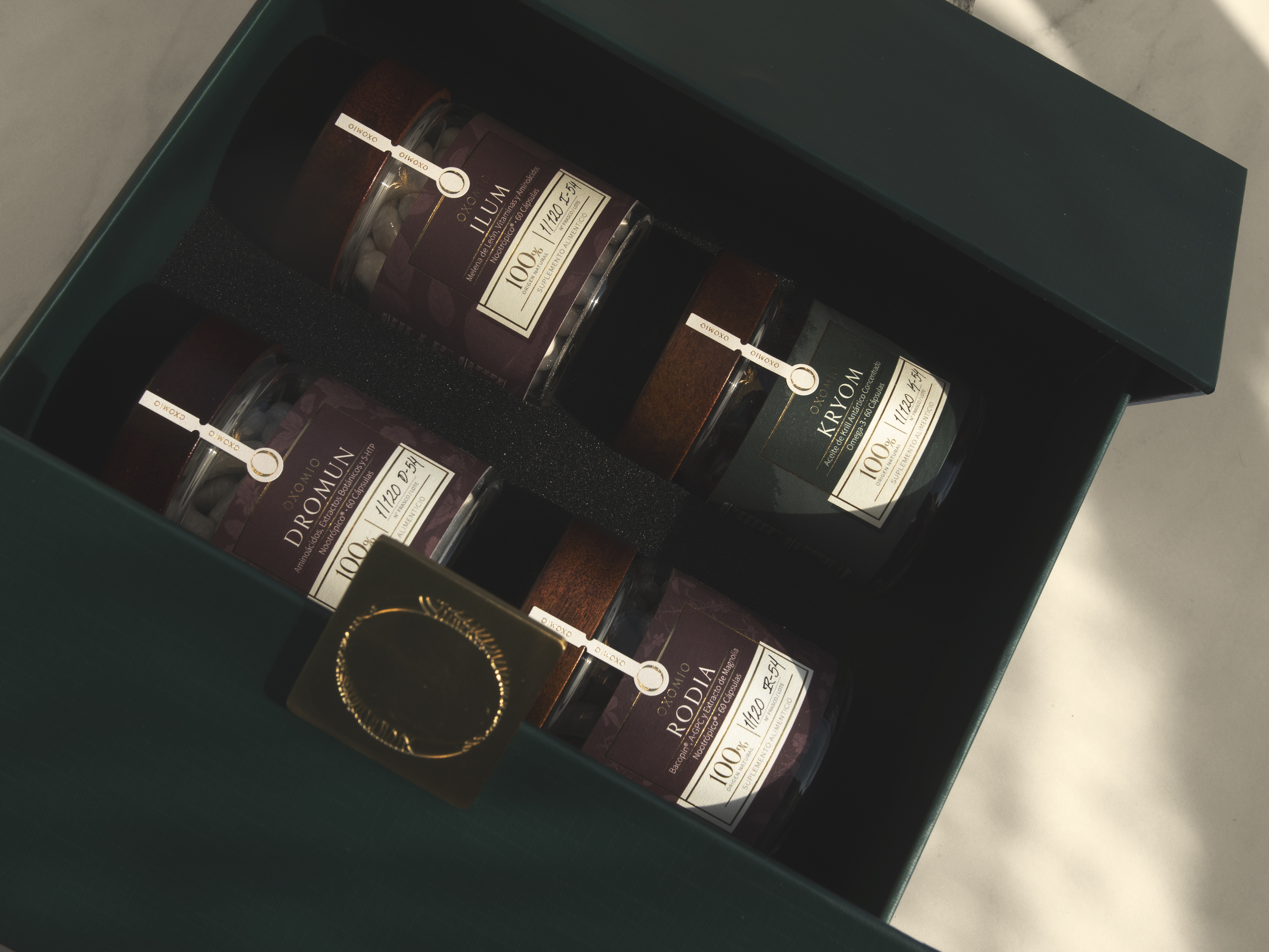 OXOMIO boxed nootropic product set in a deep green presentation box