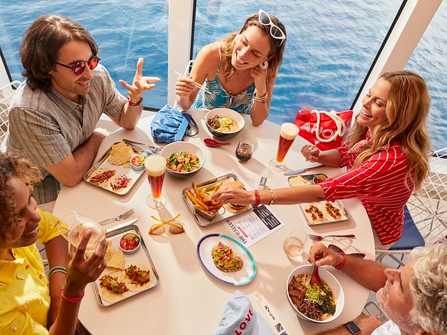 Friends sharing lunch at The Galley aboard the Valiant Lady