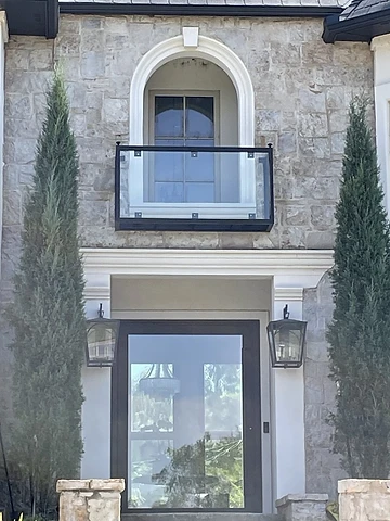 Modern balcony guard with glass panels and minimal metal frame