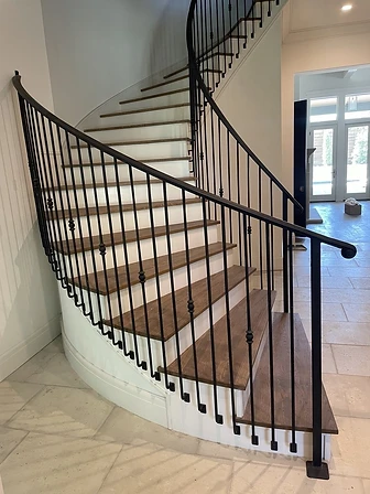 Contemporary curved iron stair railing with clean minimal lines