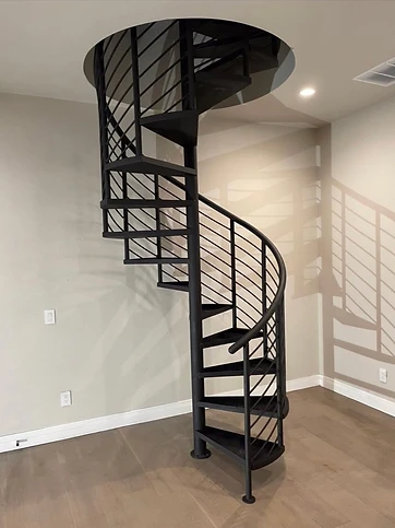 Contemporary black spiral staircase with continuous curved handrail