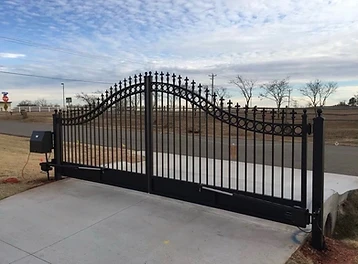 Traditional iron driveway gate with fleur-de-lis detailing