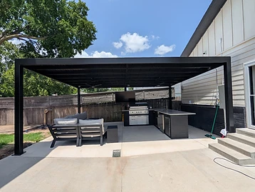 Custom black steel outdoor kitchen pergola over a residential cooking and living area