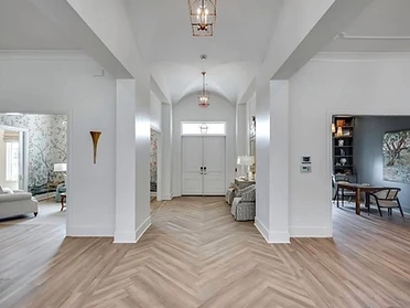 Symmetrical foyer looking toward the light-blue entry doors