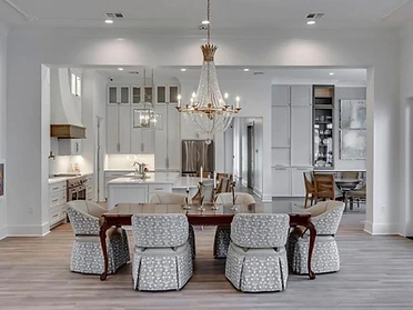 Dining room with crystal chandelier opening to kitchen