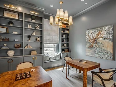 Study with slate-gray built-ins and peacock artwork