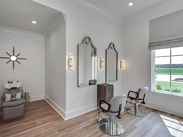 Hair salon styling room with arched mirrors and chrome chairs