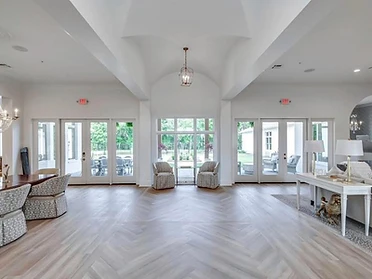 Open lobby with vaulted ceiling and chevron wood floors
