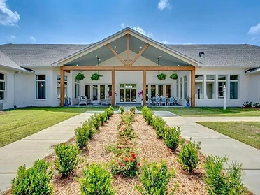 Rear exterior and covered heavy-timber patio of The Oaks