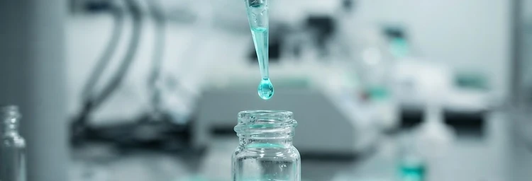 Precision robotic micropipette dispensing a droplet