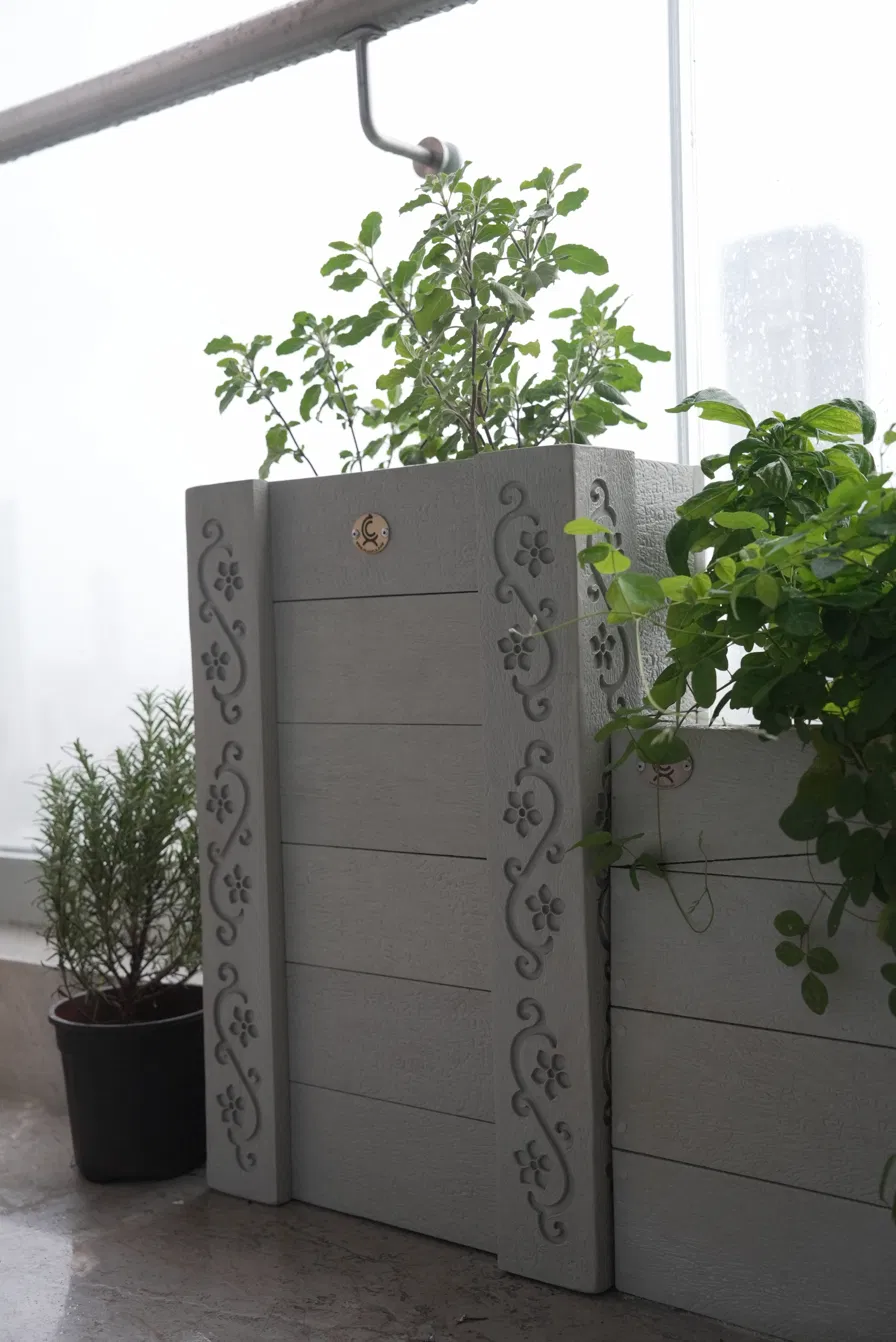 Decorative recycled plastic planter with floral motifs