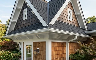 Exterior carpentry featuring cedar shake siding and roof gables on a home in Avon-by-the-Sea, NJ.
