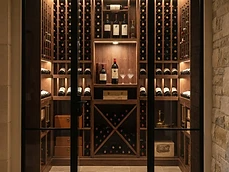 Modern custom carpentry wine cellar with glass doors and integrated lighting in Avon-by-the-Sea, NJ.
