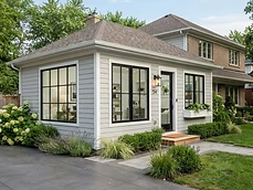 Finished ground floor Home Additions with light siding and black window frames in Rumson, NJ.