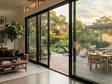 Wide sliding glass Doors & Windows connecting a modern living room to a deck in Bradley Beach, NJ.