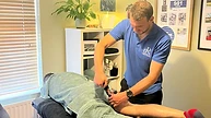 Therapist performing sports massage on a client