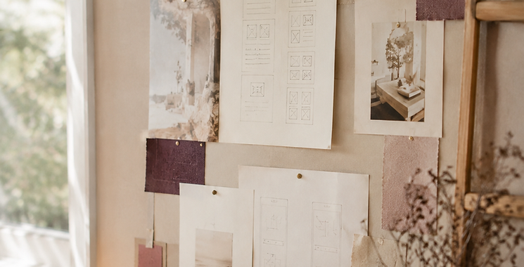 Mur de pilotage de projet : wireframes, échantillons de matières et documents épinglés, lumière naturelle.