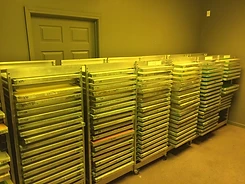 Clean screens stacked on carts in the darkroom