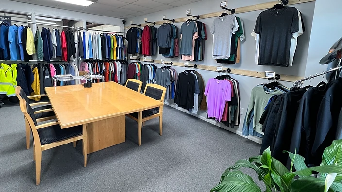 SeaSide Silk Screening showroom with apparel display racks and conference table