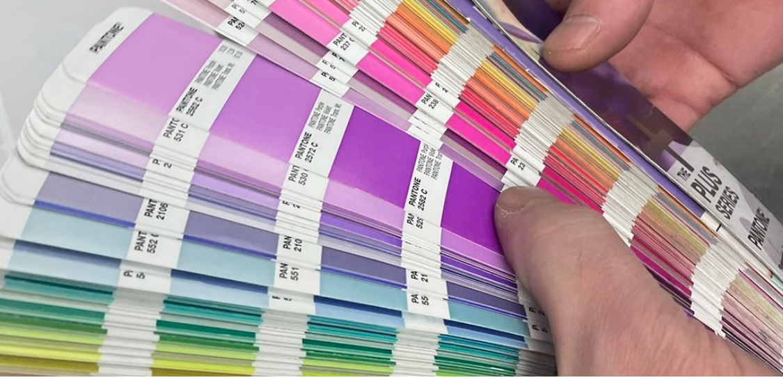 Pantone Plus Series coated color fan deck held open
