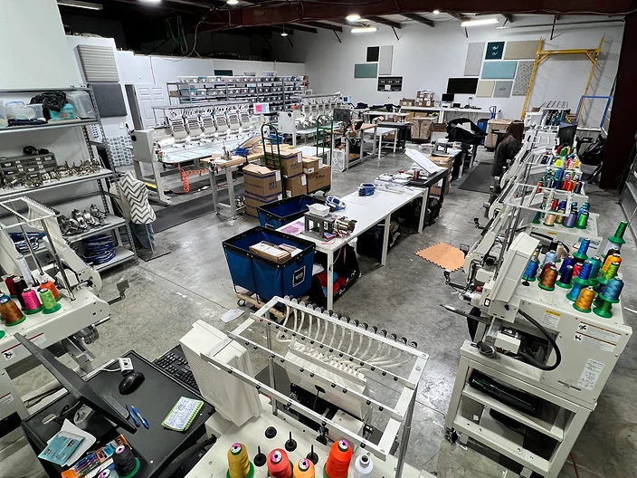 SeaSide Silk Screening embroidery production floor with multi-head machines and thread racks