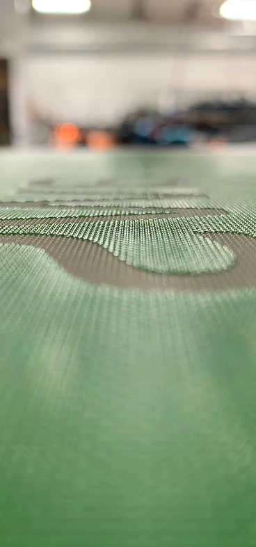 Macro shot of a finished screen — crisp stencil detail in the emulsion
