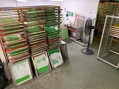 Organized screen storage racks with labeled mesh counts