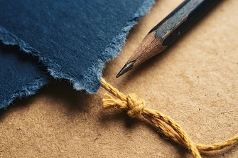 Macro detail of paper, pencil and string textures