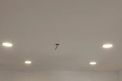 Freshly painted white ceiling with recessed lighting during an interior renovation by All Aspects