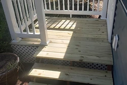 Wood deck and stairs with white railing built by All Aspects