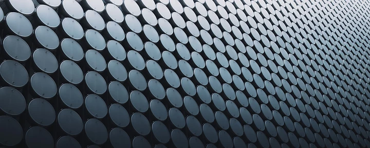 Curved metallic disc facade with wave geometry