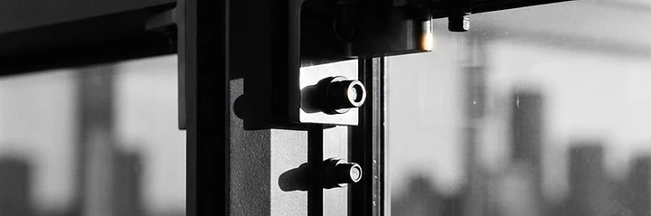 Architectural close-up of a structural steel and glass building joint
