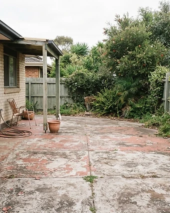 Weathered patio with flaking paint coating and faded sealer