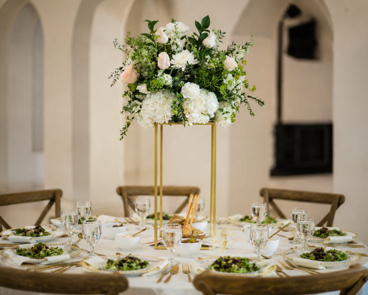 Formal wedding table with a tall floral centerpiece