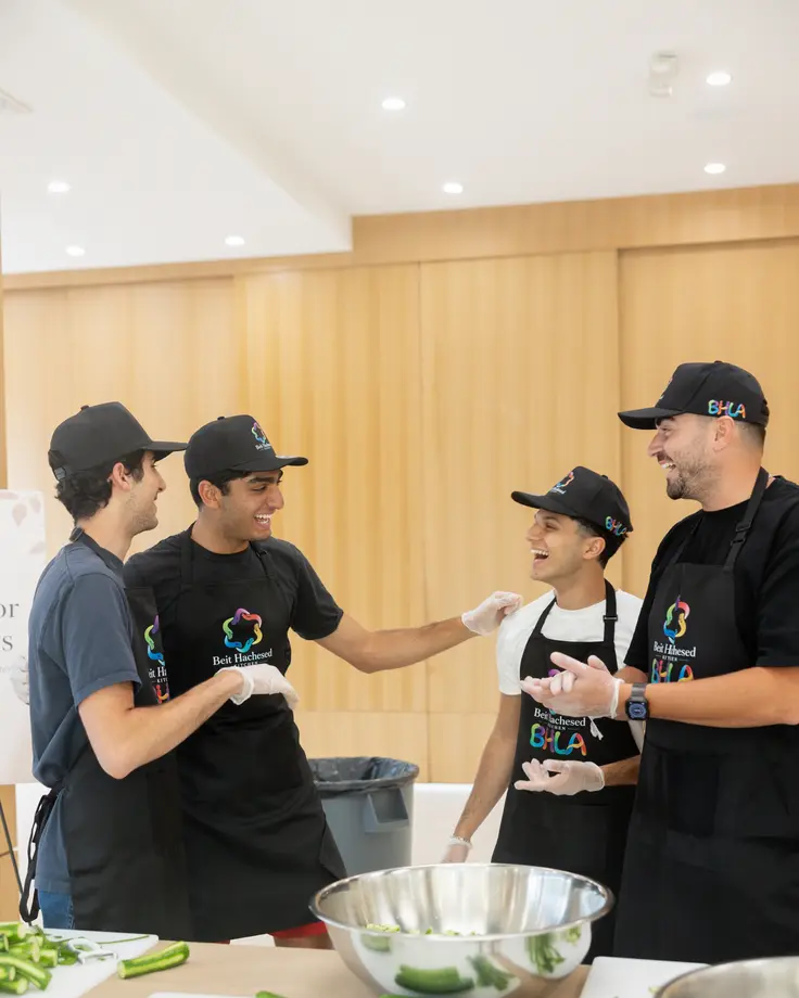 Beit Hachesed volunteers preparing meals together in the kitchen
