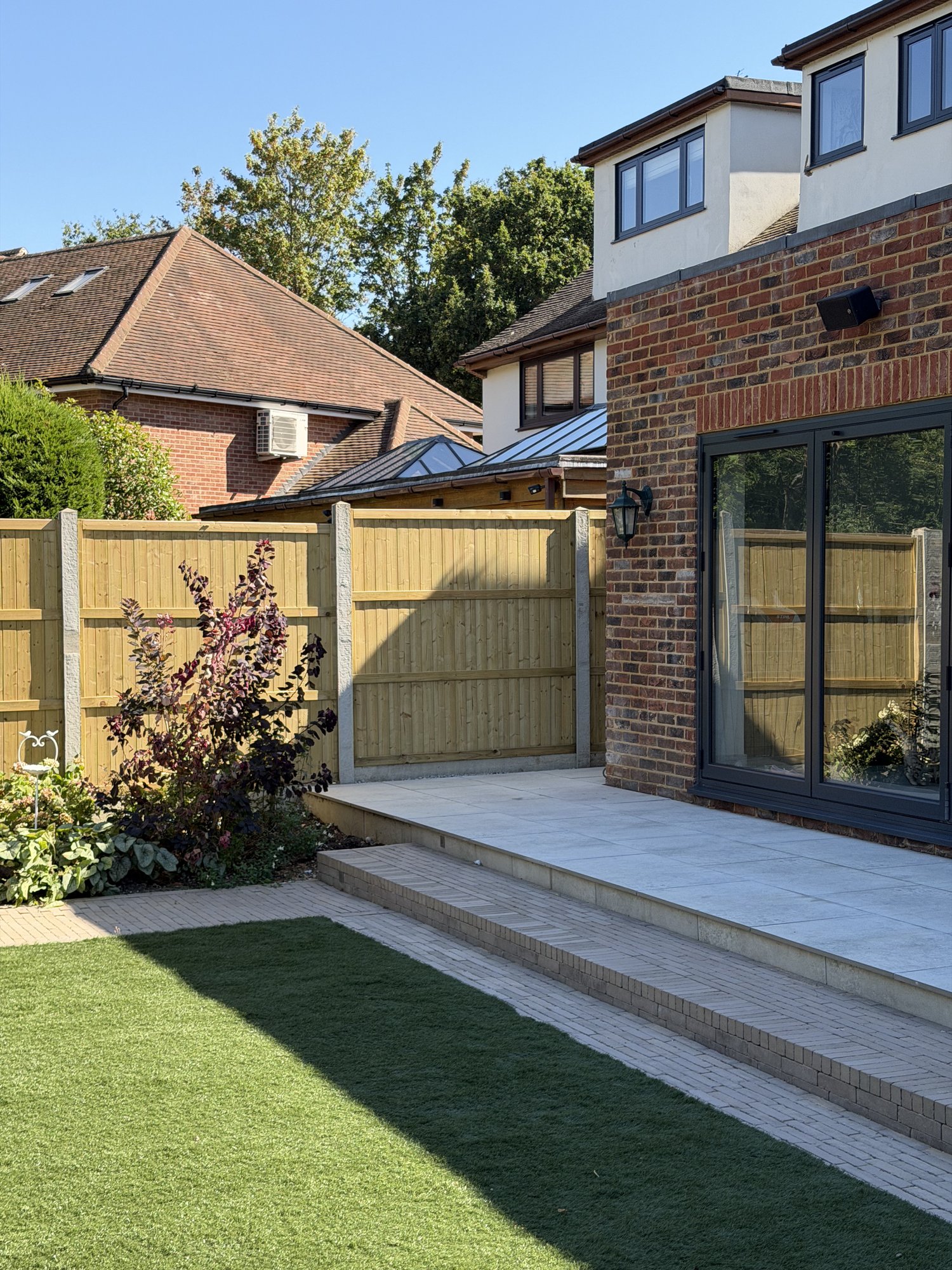 Split-level terrace, steps and bifold doors