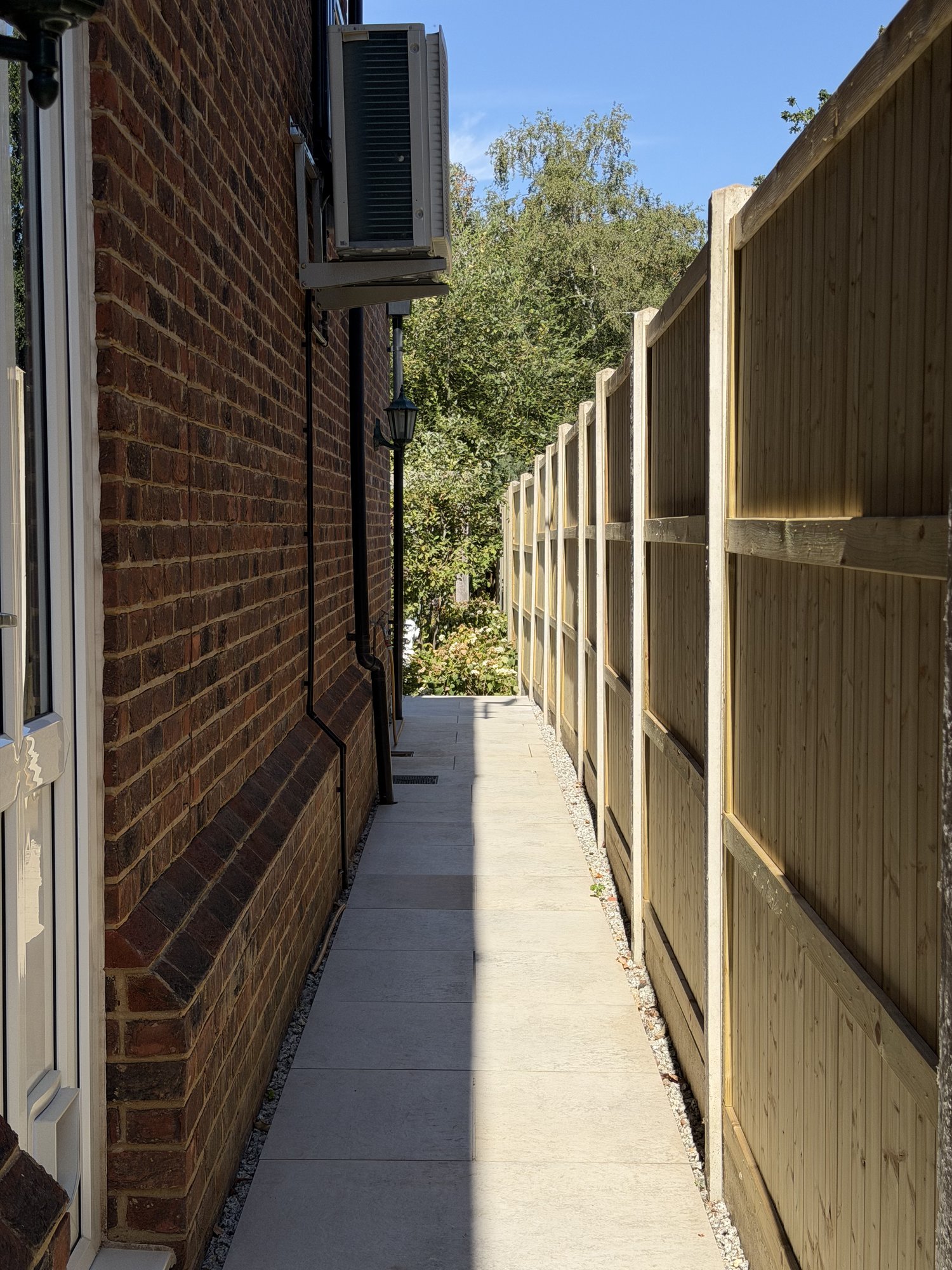 Side-access path and brick wall