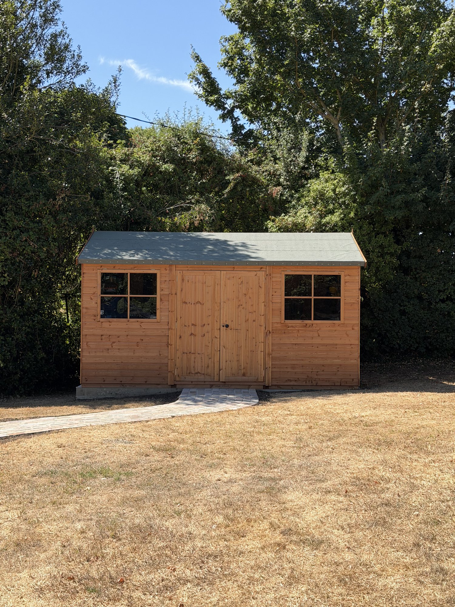 Garden shed on a paved path