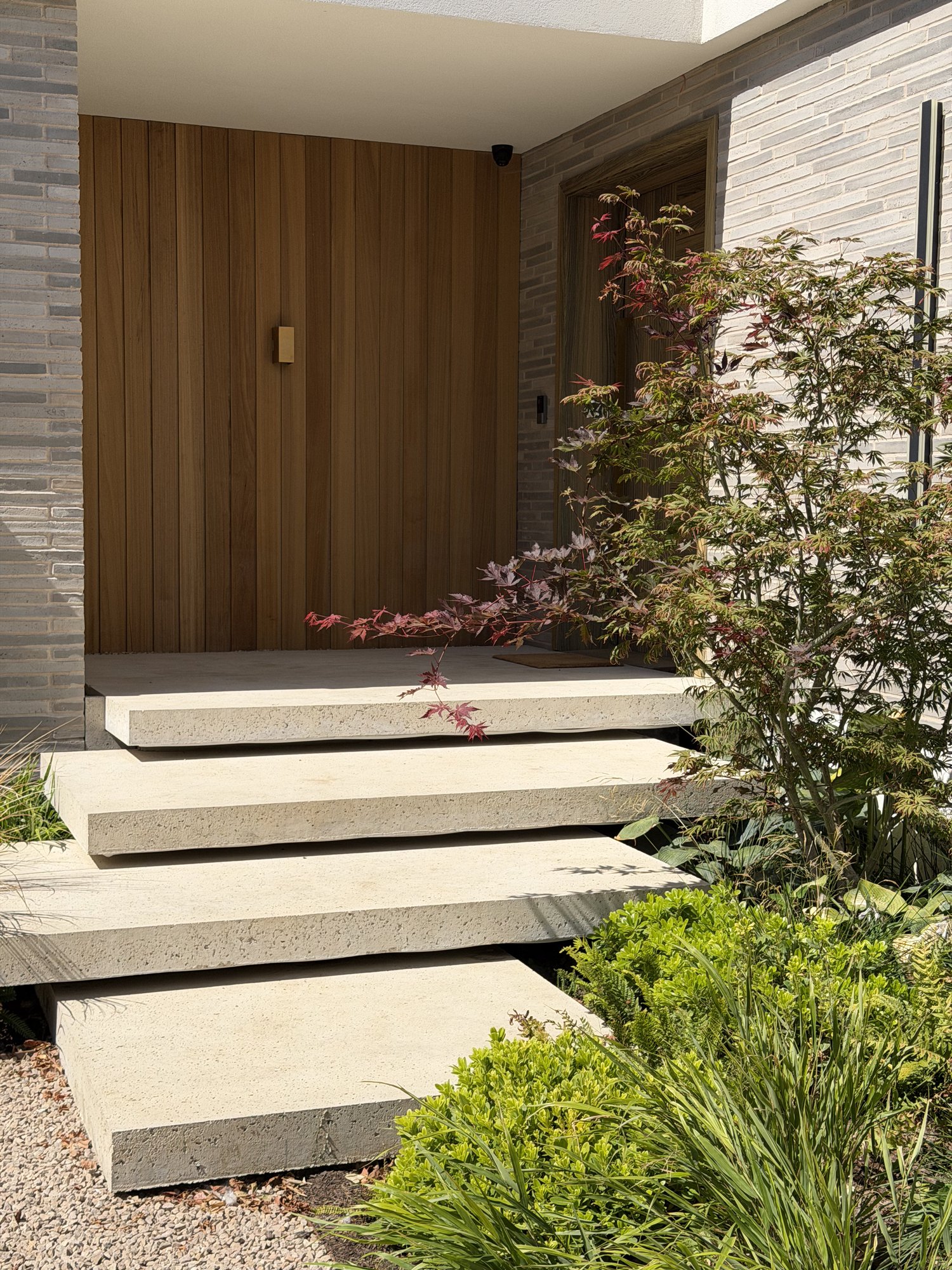 Timber-slat door and floating steps