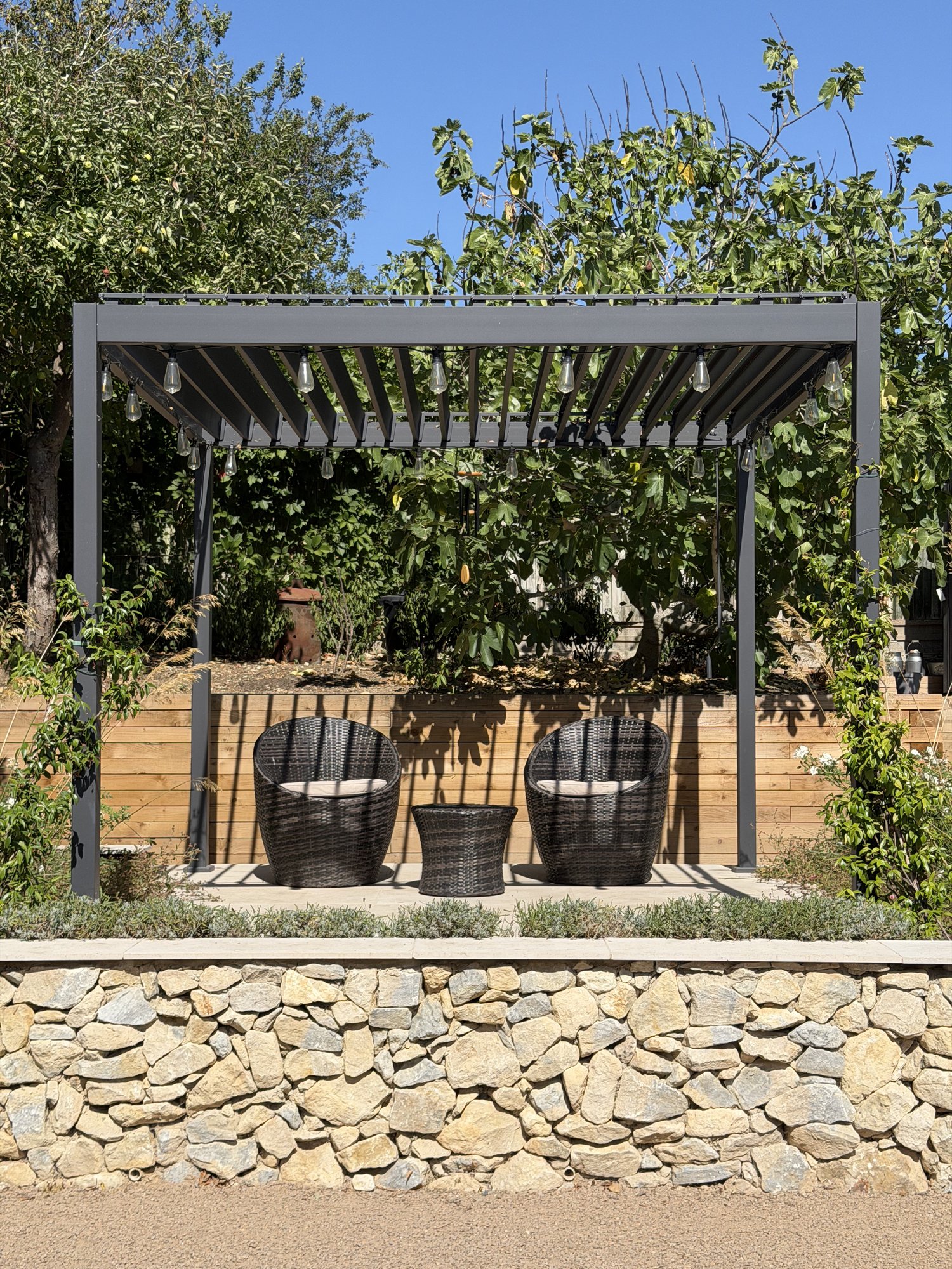 Pergola seating under string lights
