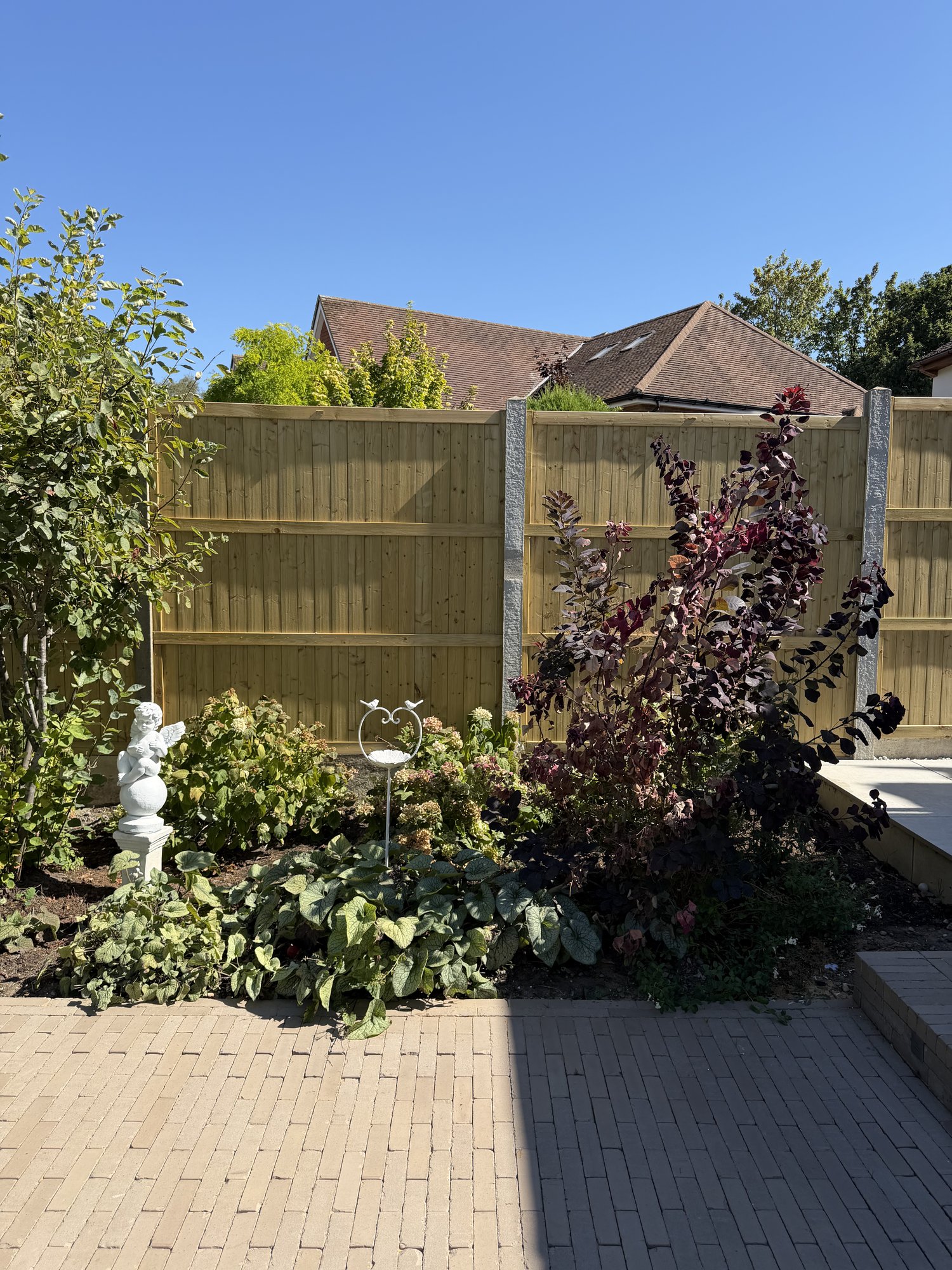 Garden bed, statue and bird feeder
