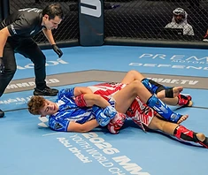 Youth fighter controlling opponent on the mat