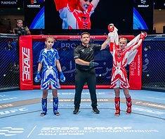 Young girl fighter ready in the cage at IMMAF