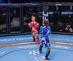 AVT youth girl stands ready in cage corner