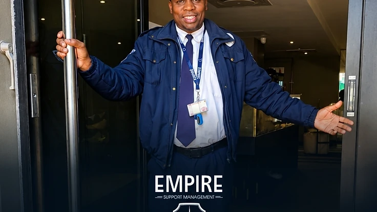 Empire security officer in uniform welcoming visitors at a building entrance in Cape Town