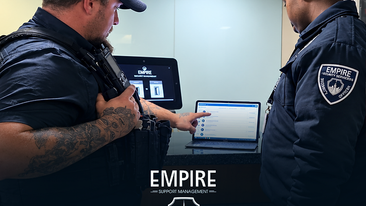 Empire security officers reviewing live site reports on the EMR system at a reception desk in Cape Town