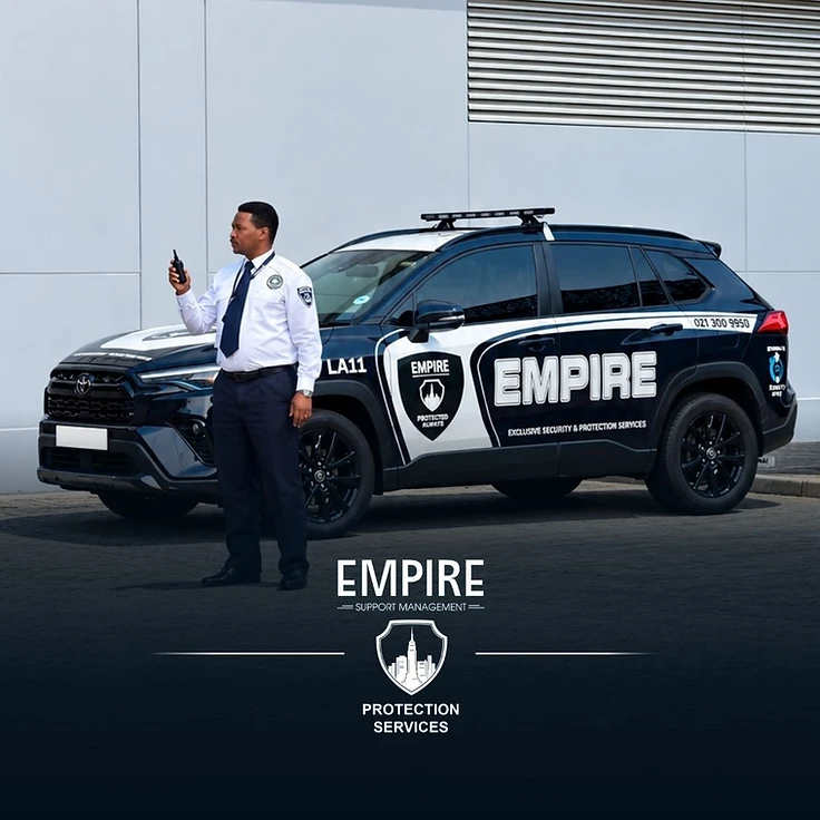 Empire security officer with radio standing next to a branded Empire patrol vehicle in Cape Town
