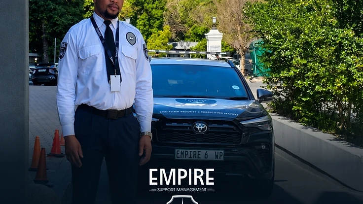 Empire security officer standing with a branded vehicle at a residential estate driveway