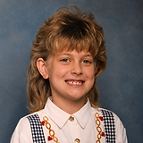 Vintage studio portrait of a smiling girl in a gingham-suspendered shirt